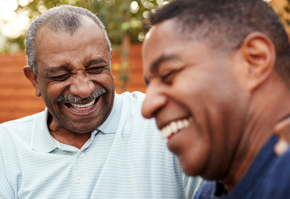 Two senior African American Men laughing